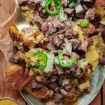 carne asada fries with onion, cilantro and jalapenos